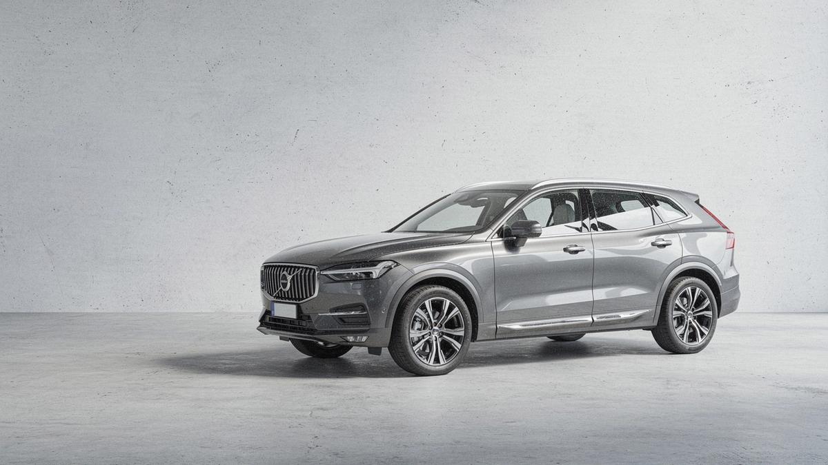 Grey luxury SUV photographed from the front left on a plain floor